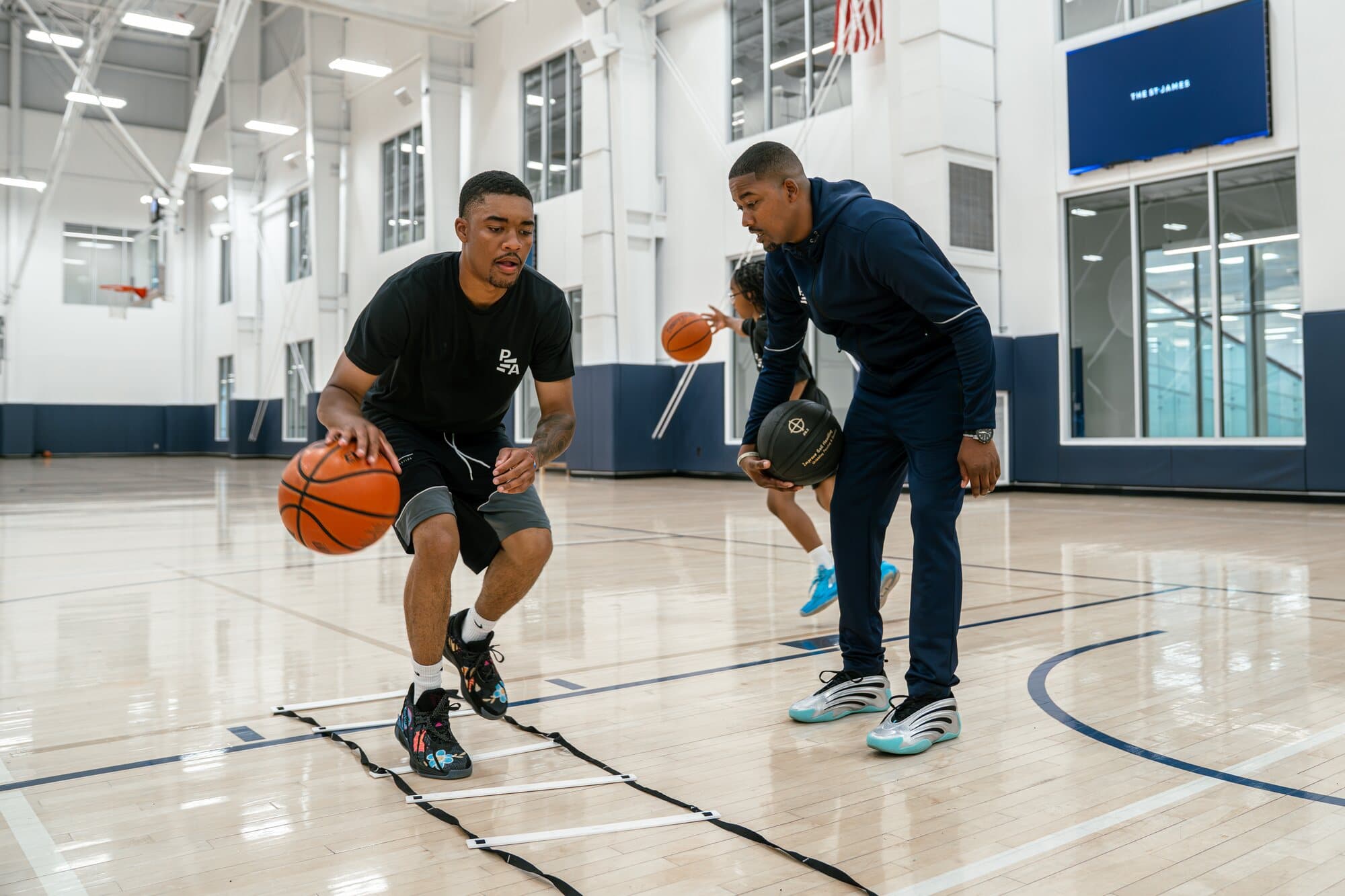 A Petty Athletics athlete working through a ladder drill as Rashad Petty coaches
