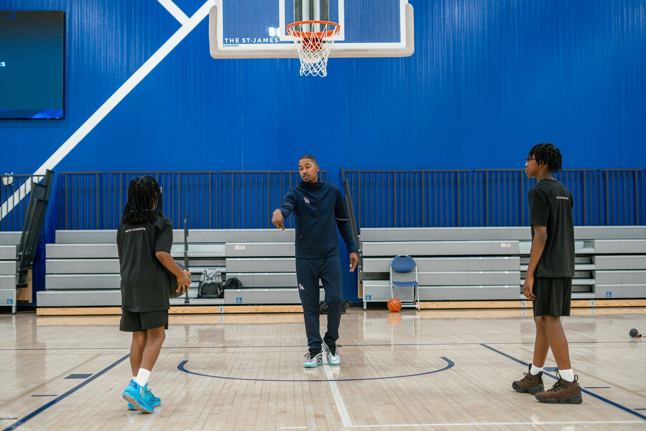 Rashad Petty coaching two athletes during a basketball training session