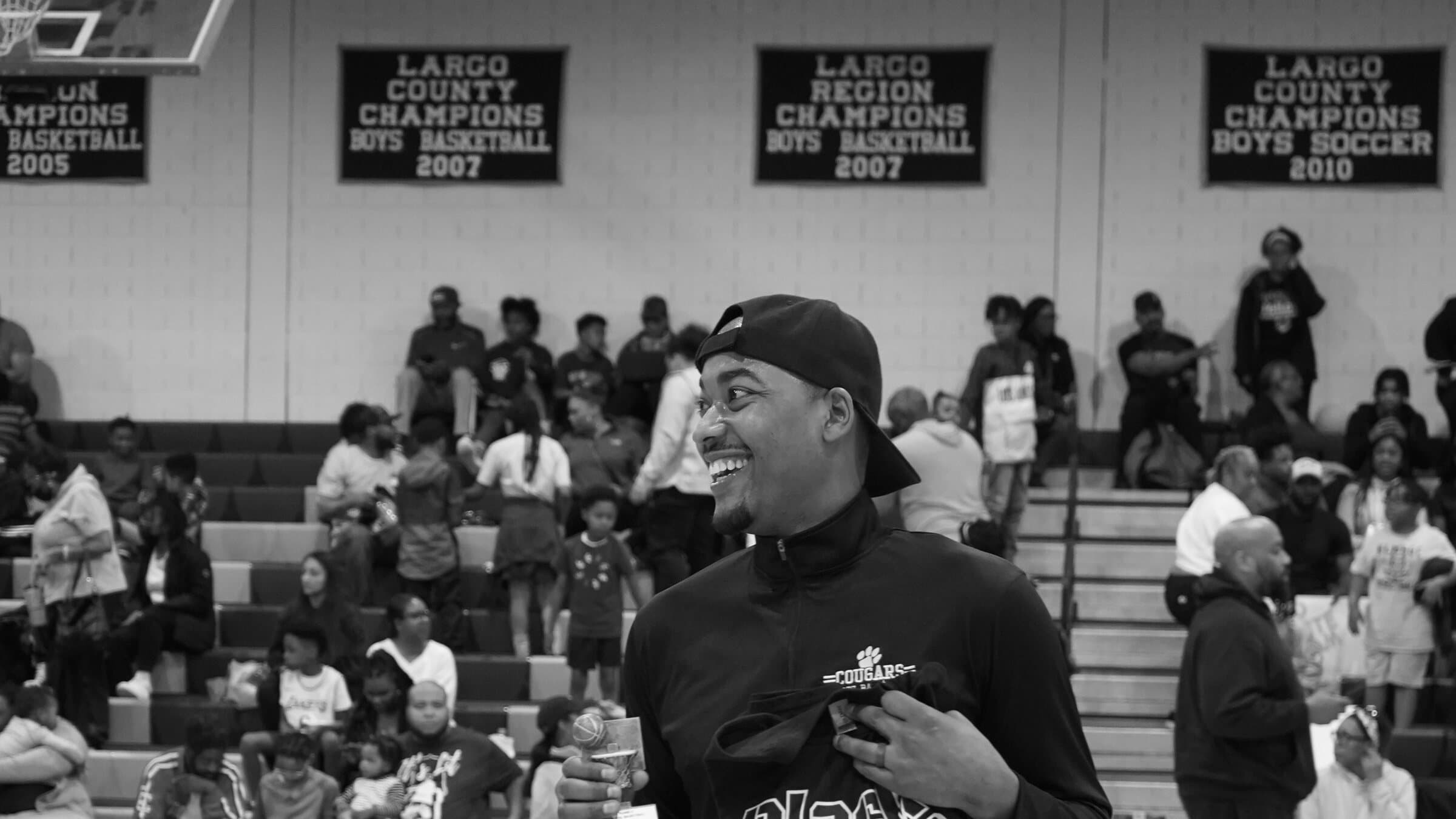 Rashad Petty smiling on the court during a community basketball event
