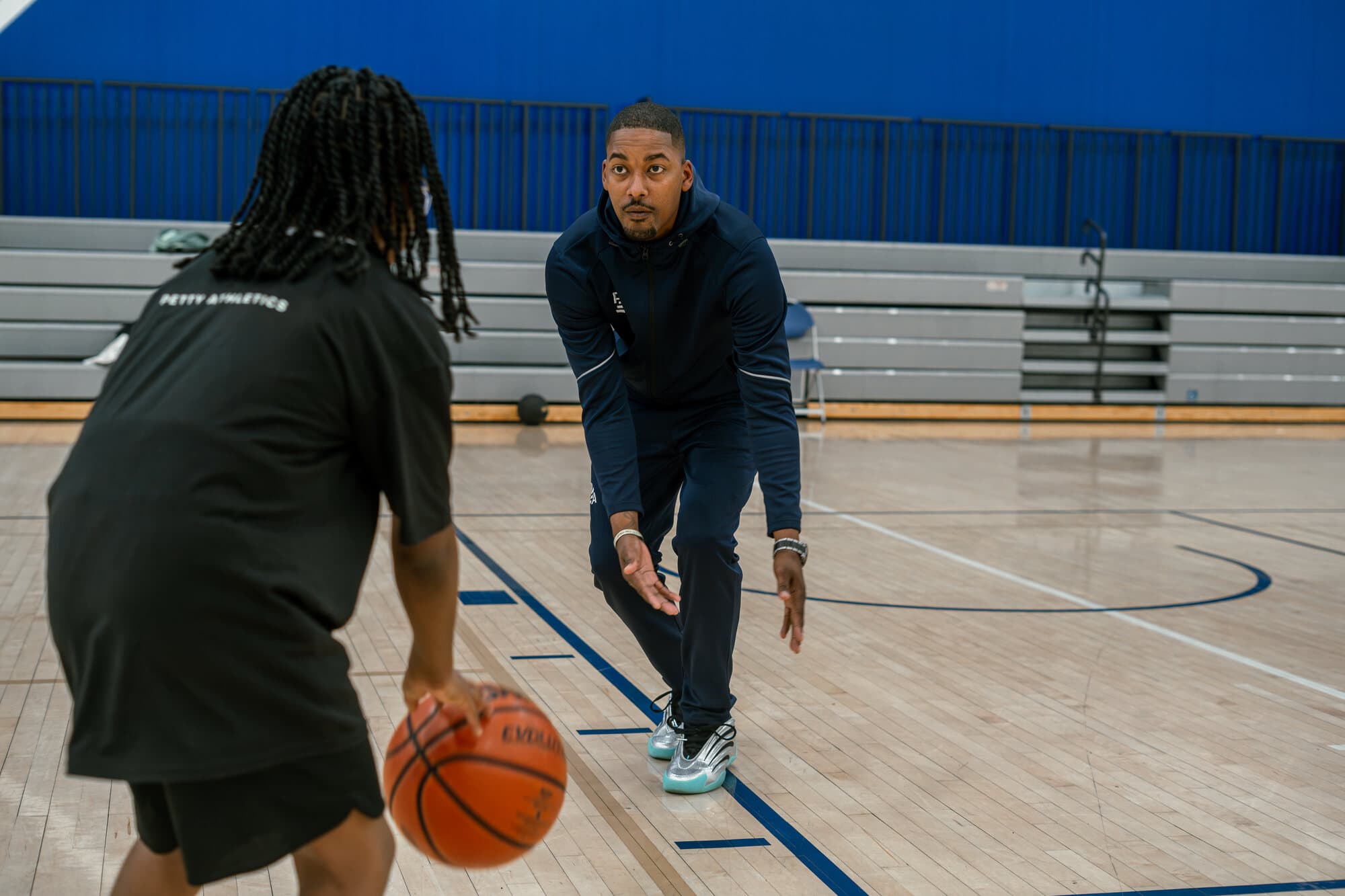 Rashad Petty demonstrating a basketball stance during a training session